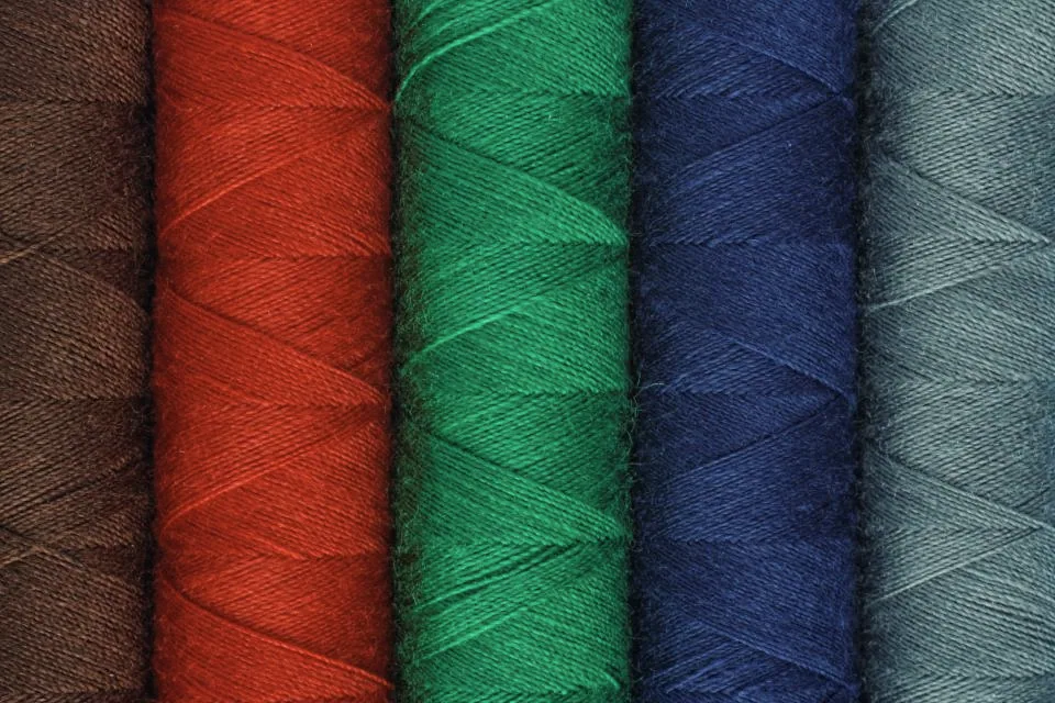Stacks of sewing thread photographed closely (conceptual image)